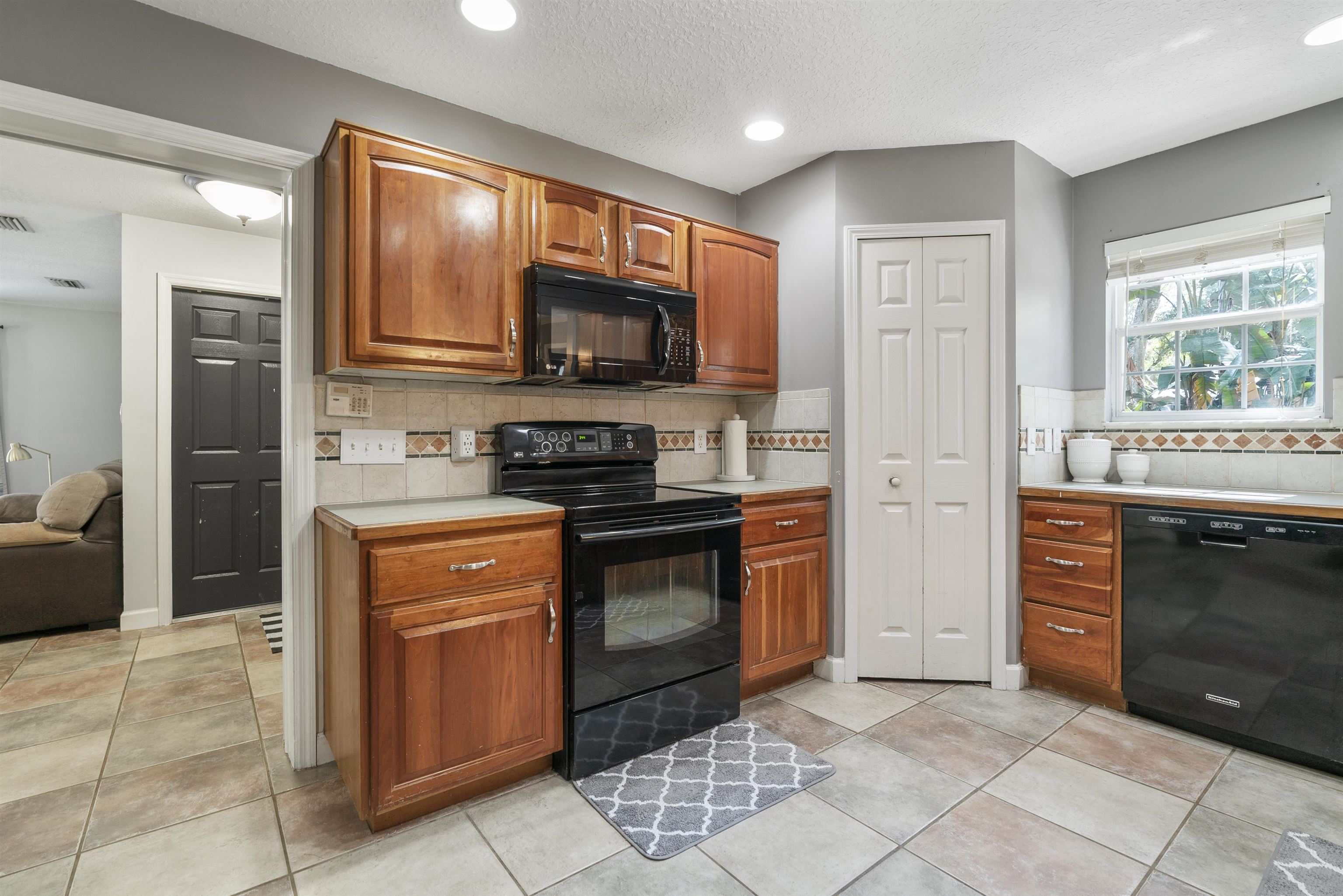 246 Mimosa Road St. Augustine, FL 32086 - Photo 22 of 45 a kitchen with stainless steel appliances granite countertop a stove top oven a sink dishwasher a refrigerator and a microwave