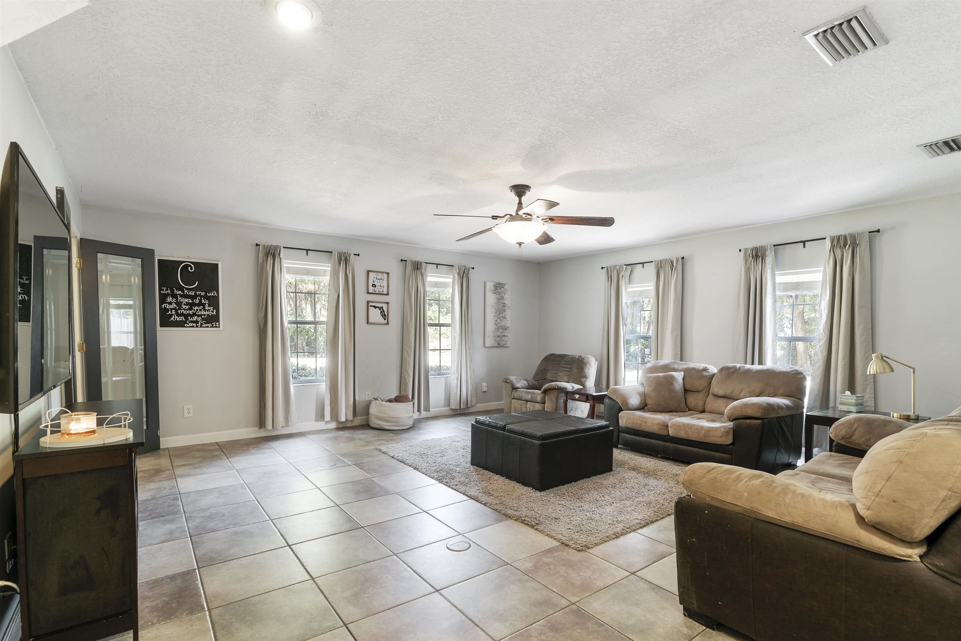 246 Mimosa Road St. Augustine, FL 32086 - Photo 26 of 45 a living room with furniture and a dining table with kitchen view