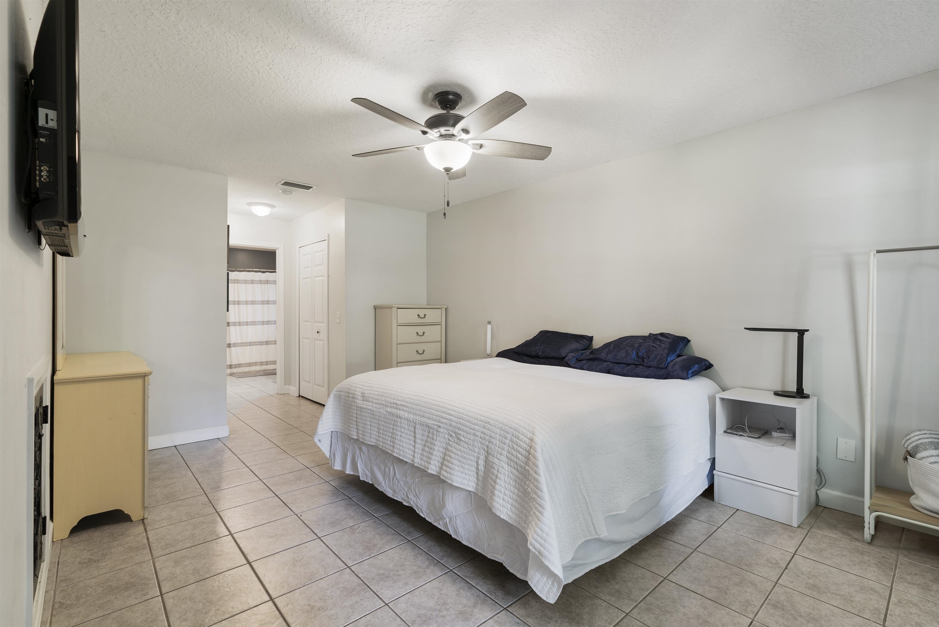 246 Mimosa Road St. Augustine, FL 32086 - Photo 27 of 45 a bedroom with a bed and a flat tv screen on the dresser