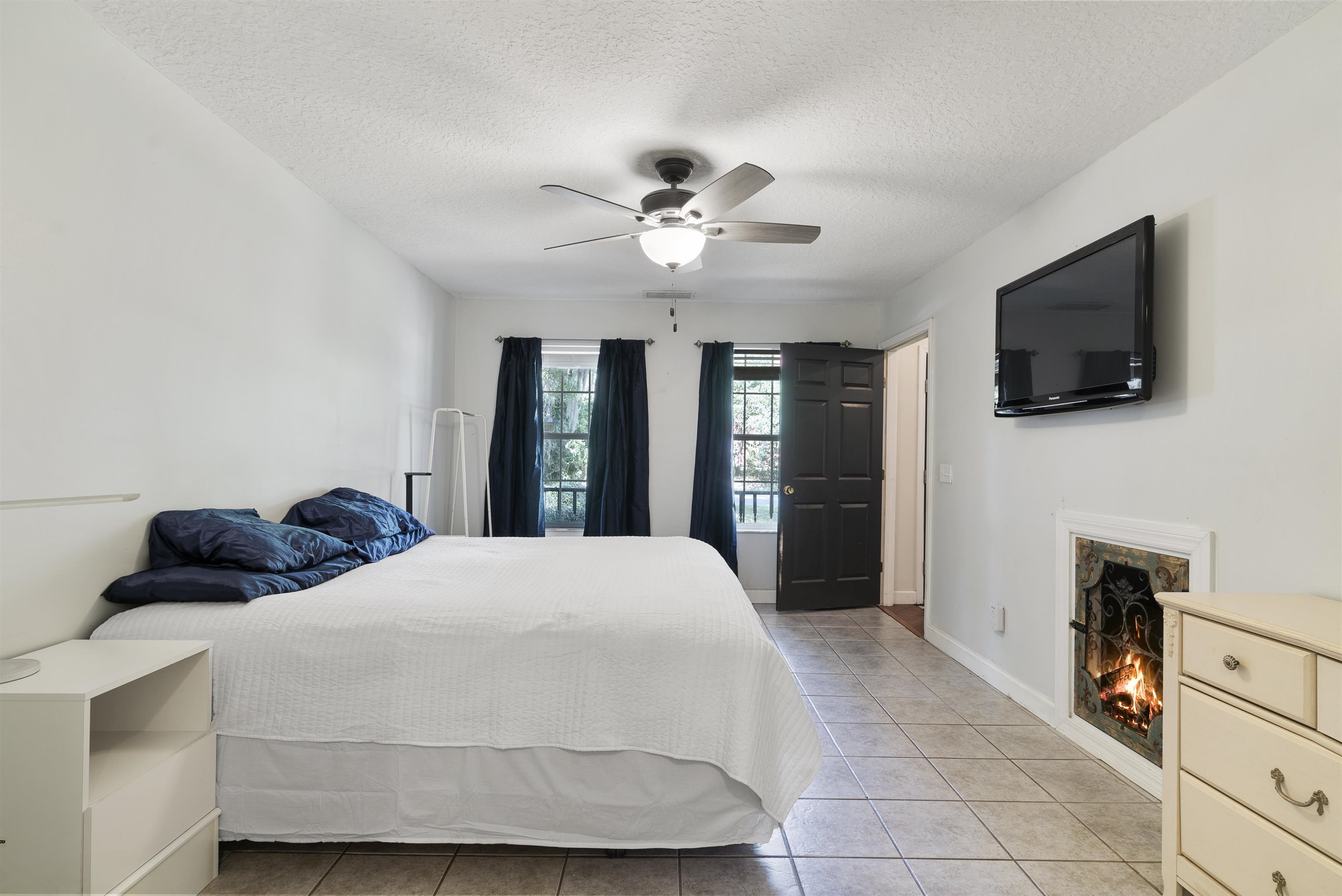 246 Mimosa Road St. Augustine, FL 32086 - Photo 28 of 45 a bedroom with a bed and a flat tv screen on dresser
