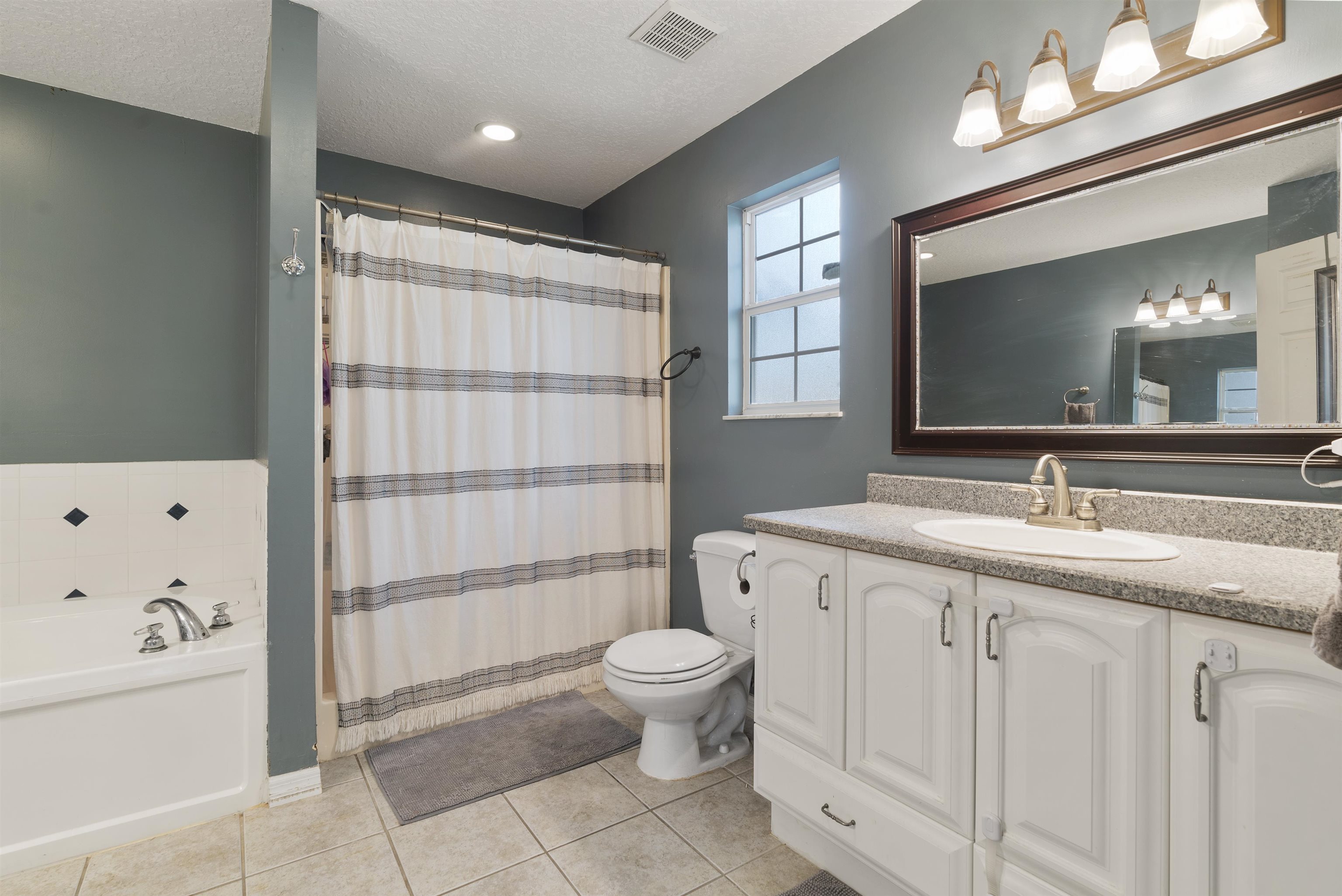 246 Mimosa Road St. Augustine, FL 32086 - Photo 30 of 45 a spacious bathroom with a toilet sink and mirror