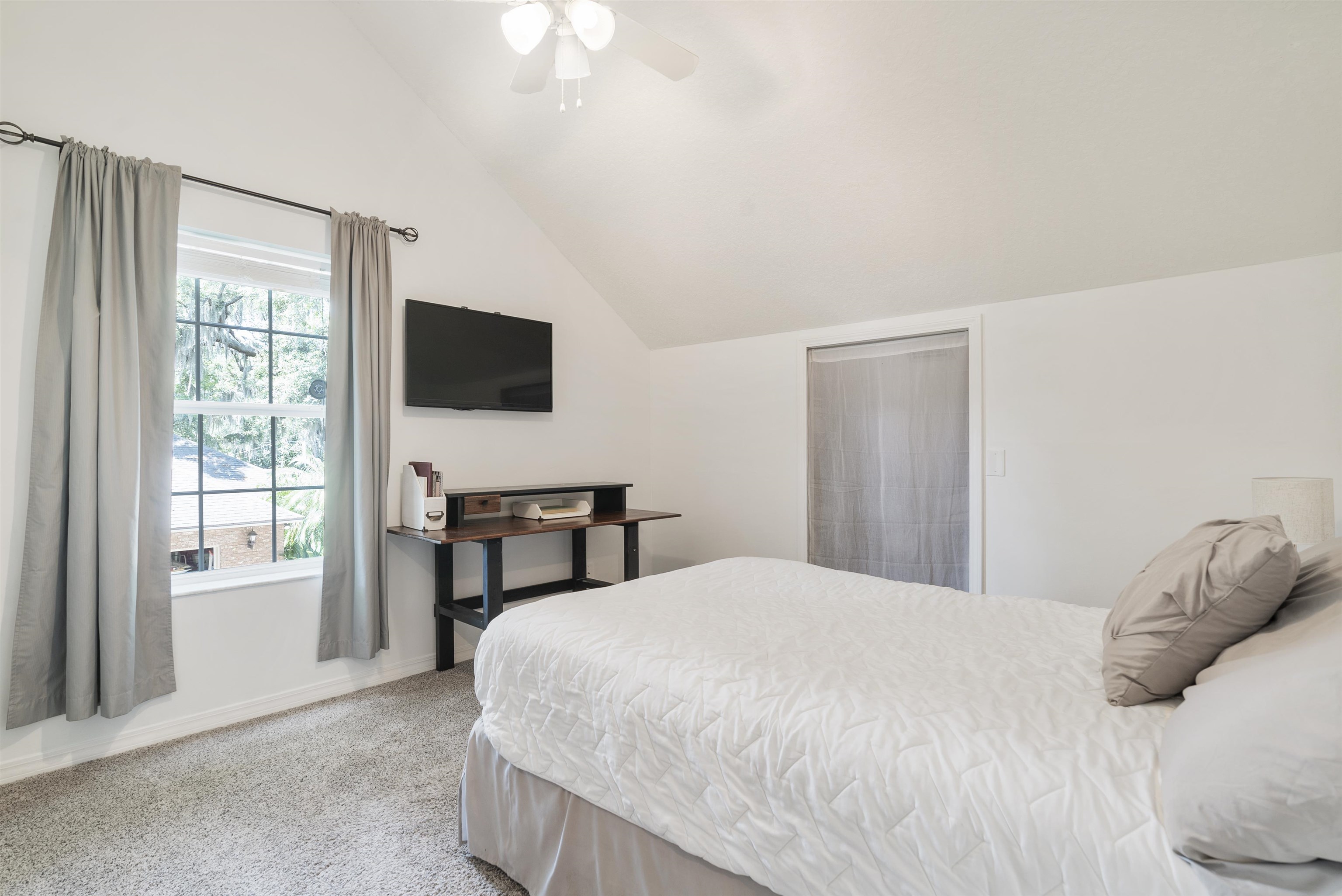 246 Mimosa Road St. Augustine, FL 32086 - Photo 35 of 45 a bedroom with a bed and a flat screen tv