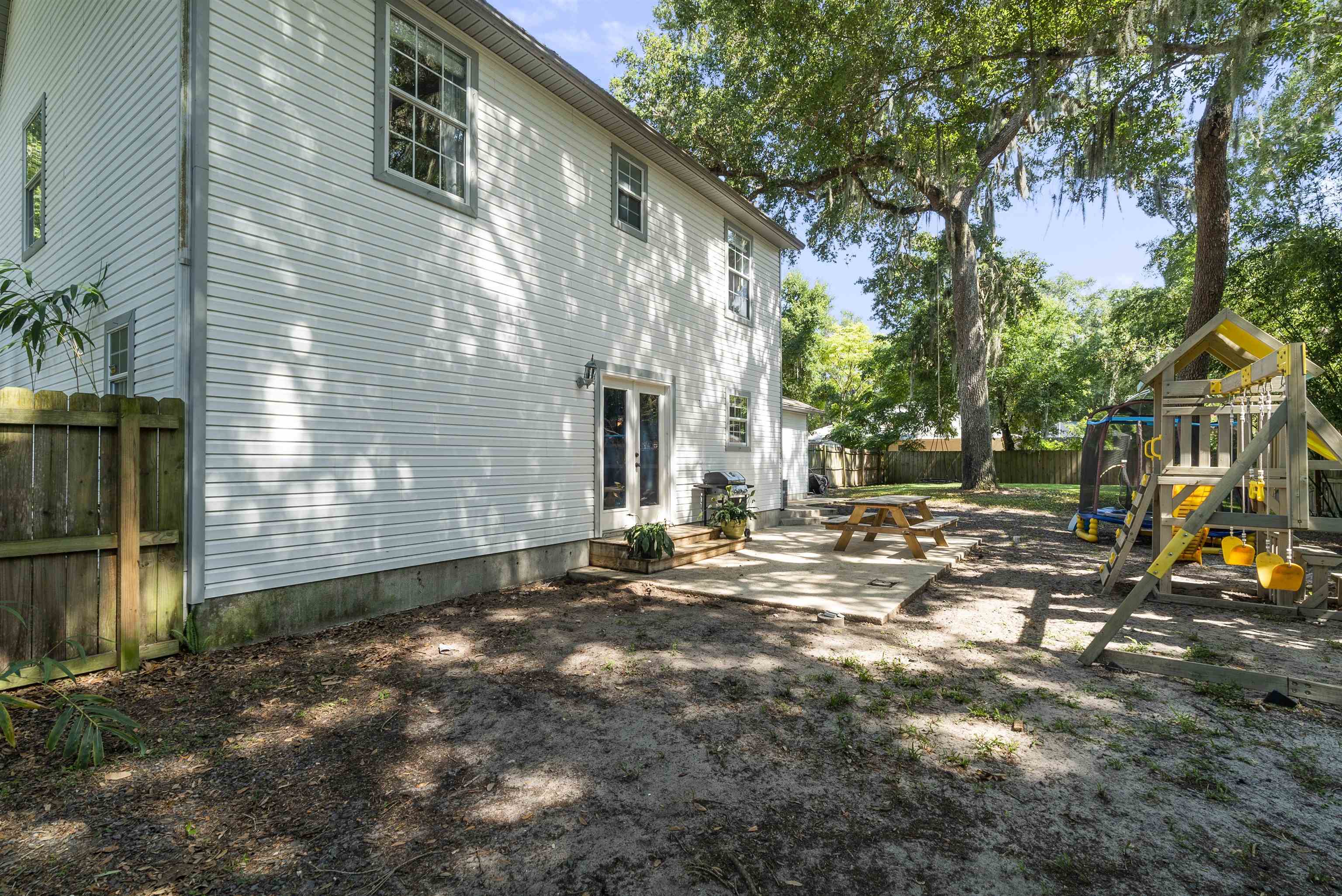 246 Mimosa Road St. Augustine, FL 32086 - Photo 45 of 45 a backyard of a house with barbeque oven table and chairs