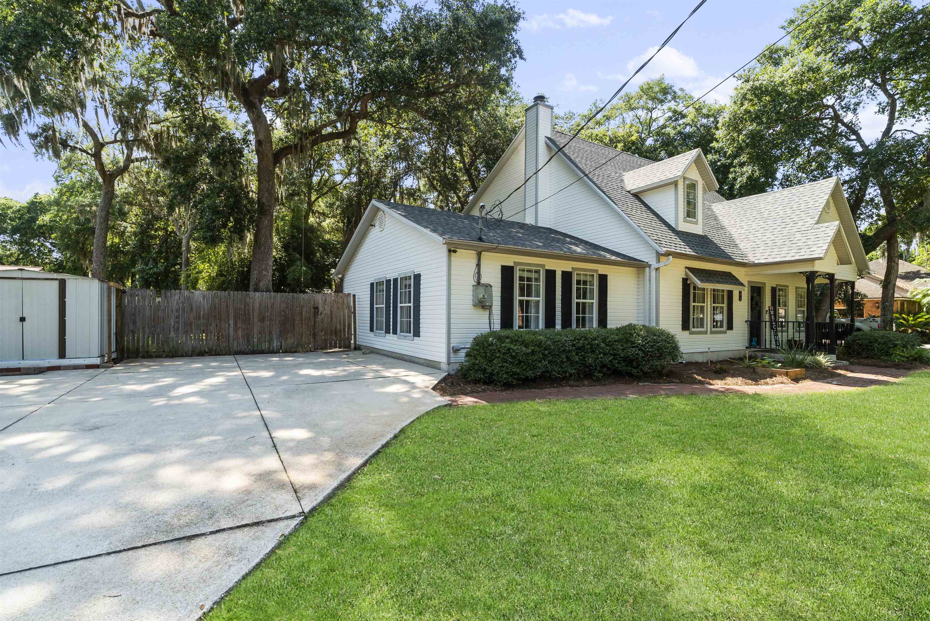 246 Mimosa Road St. Augustine, FL 32086 - Photo 5 of 45 a view of a yard in front of a house with plants and large tree