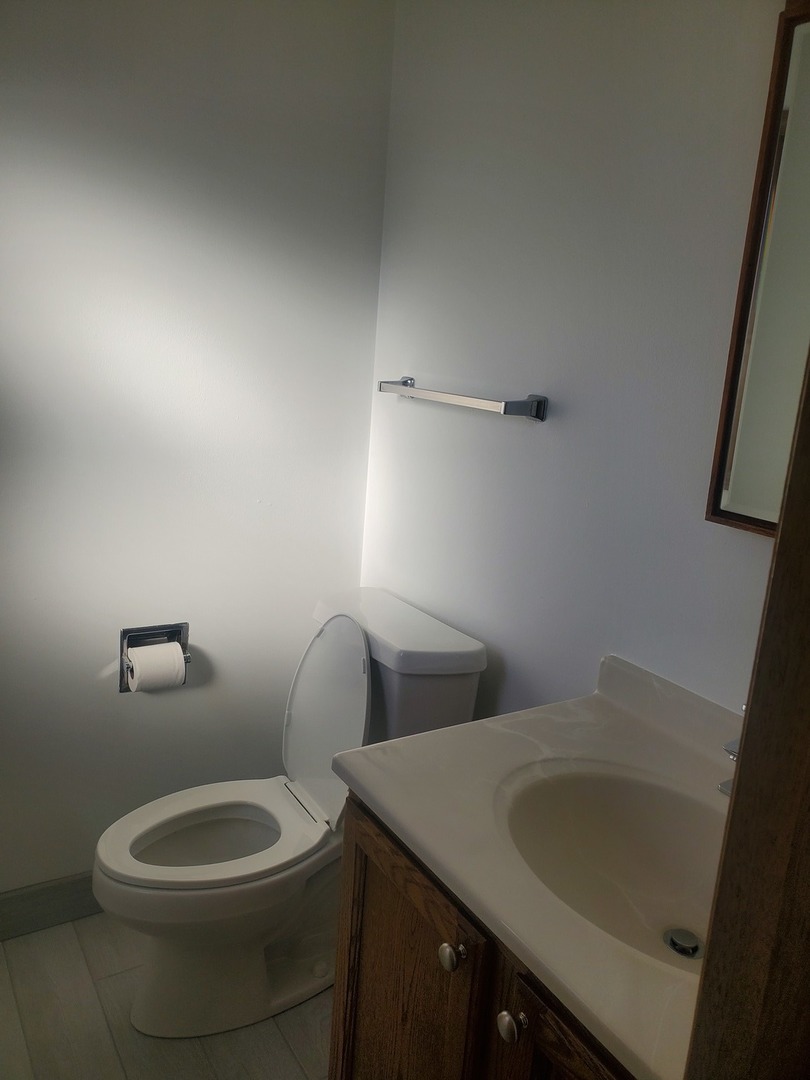 508 Ida Court, Unit 2 Mount Prospect, IL 60056 - Photo 13 of 13 a bathroom with a toilet sink and mirror