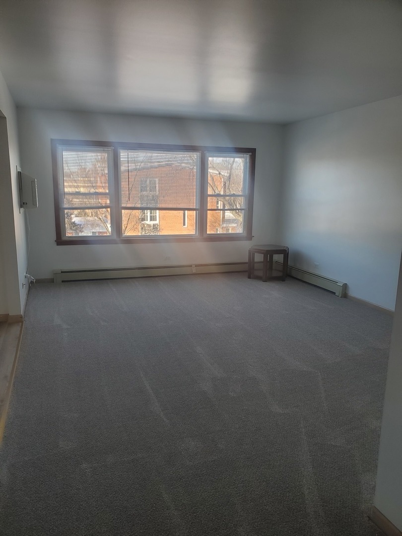 508 Ida Court, Unit 2 Mount Prospect, IL 60056 - Photo 2 of 13 an empty room with a window