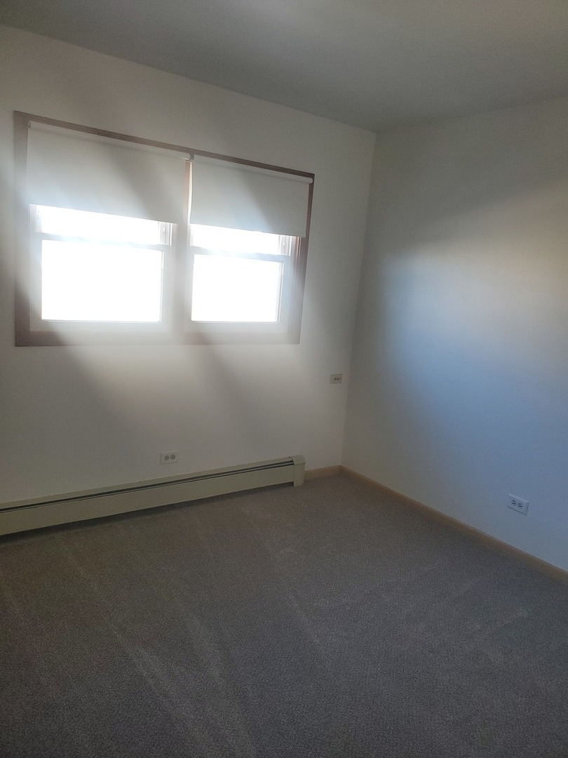 508 Ida Court, Unit 2 Mount Prospect, IL 60056 - Photo 9 of 13 an empty room with a window