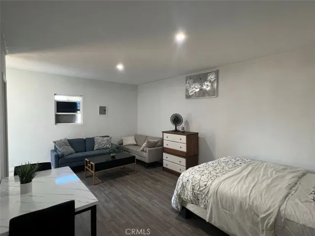 a bedroom with furniture and a wooden floor