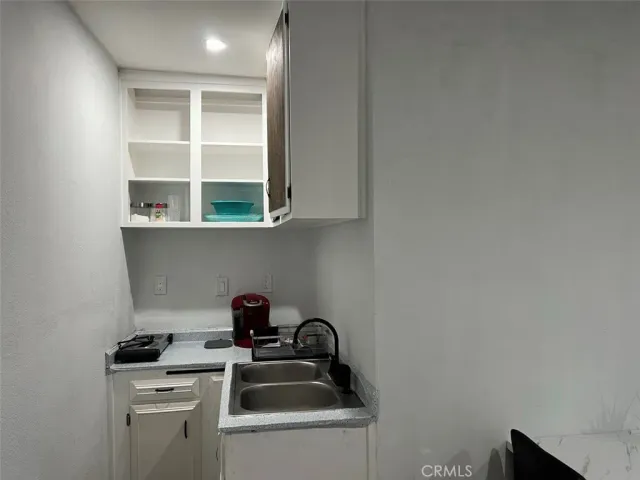 a kitchen with a sink and cabinets
