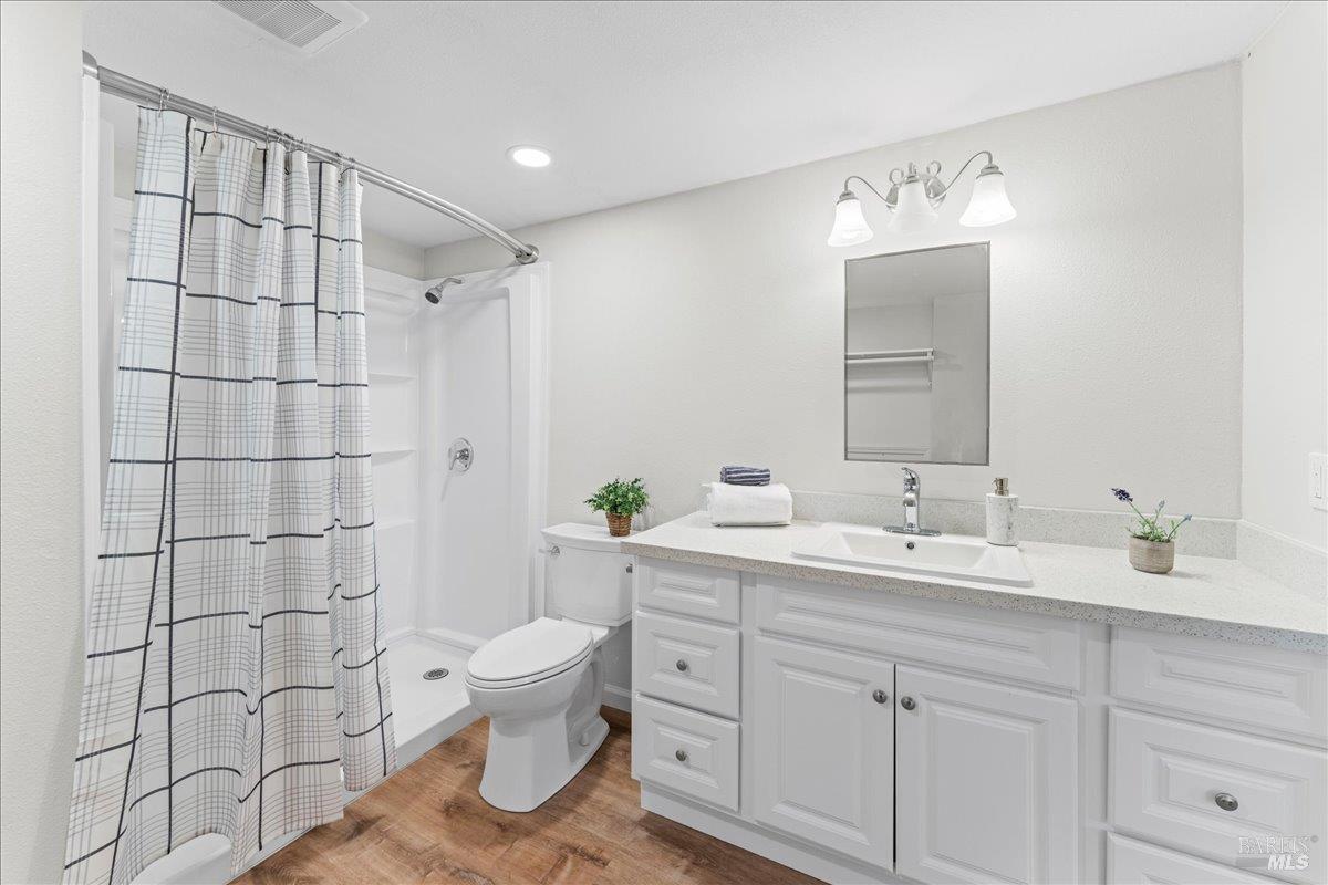 30 Fair Drive San Rafael, CA 94901 - Photo 26 of 33 a bathroom with a double vanity sink toilet and a mirror