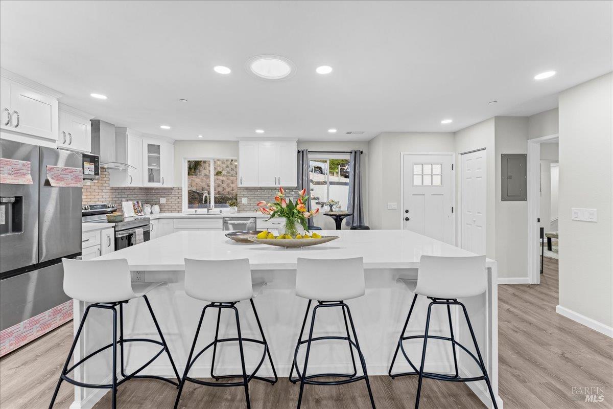 30 Fair Drive San Rafael, CA 94901 - Photo 6 of 33 a kitchen with stainless steel appliances kitchen island granite countertop a dining table chairs refrigerator and sink