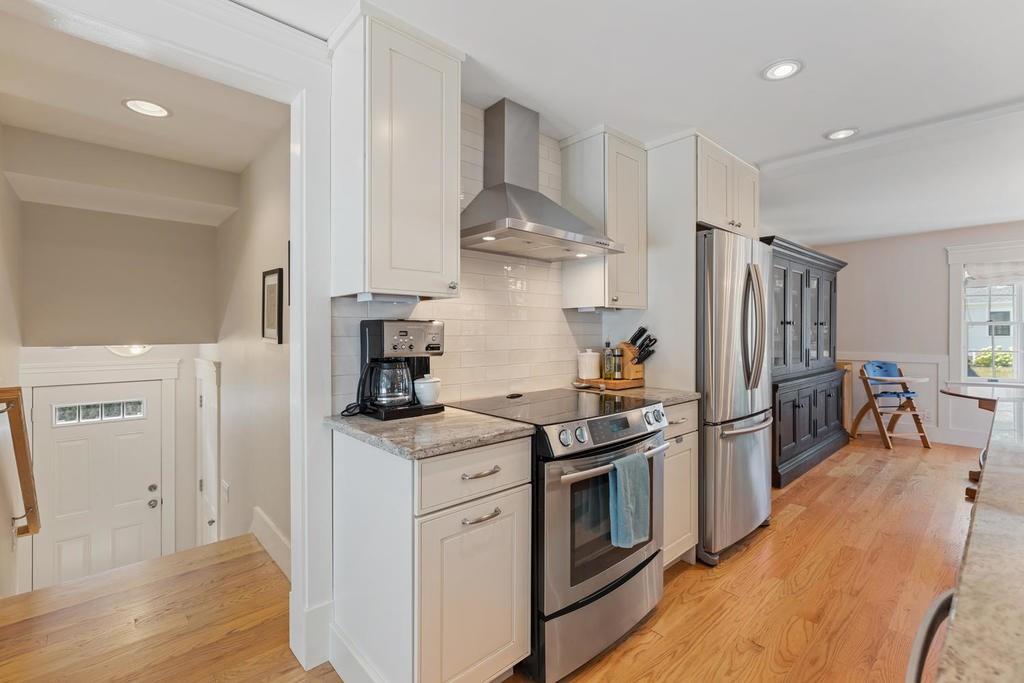 18 Moccasin Path Arlington, MA 02474 - Photo 12 of 33 a kitchen with stainless steel appliances granite countertop a sink stove and refrigerator