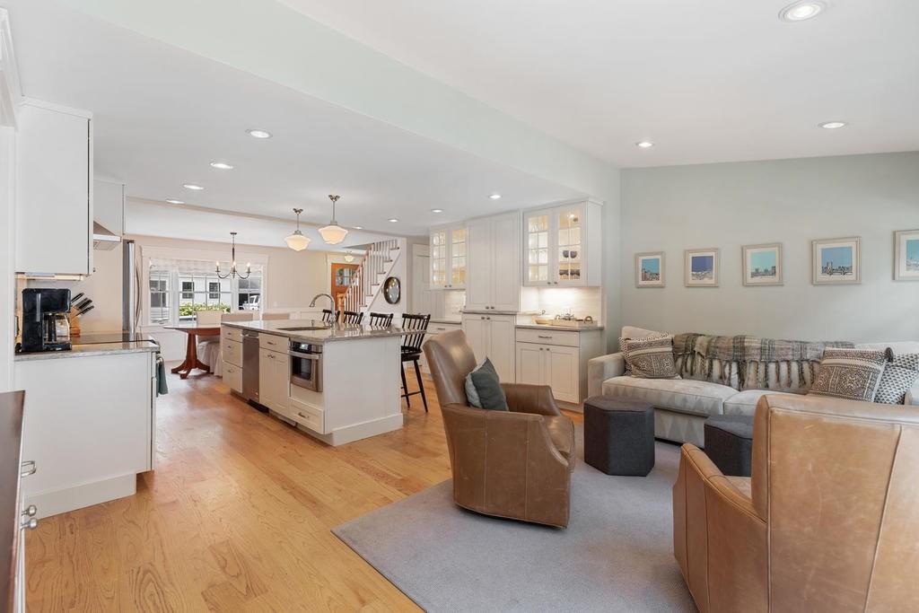 18 Moccasin Path Arlington, MA 02474 - Photo 15 of 33 a living room with couches and kitchen view with wooden floor