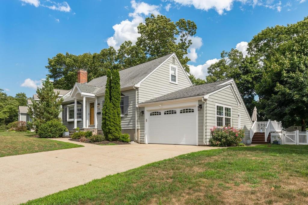 18 Moccasin Path Arlington, MA 02474 - Photo 3 of 33 a front view of a house with a yard and garage