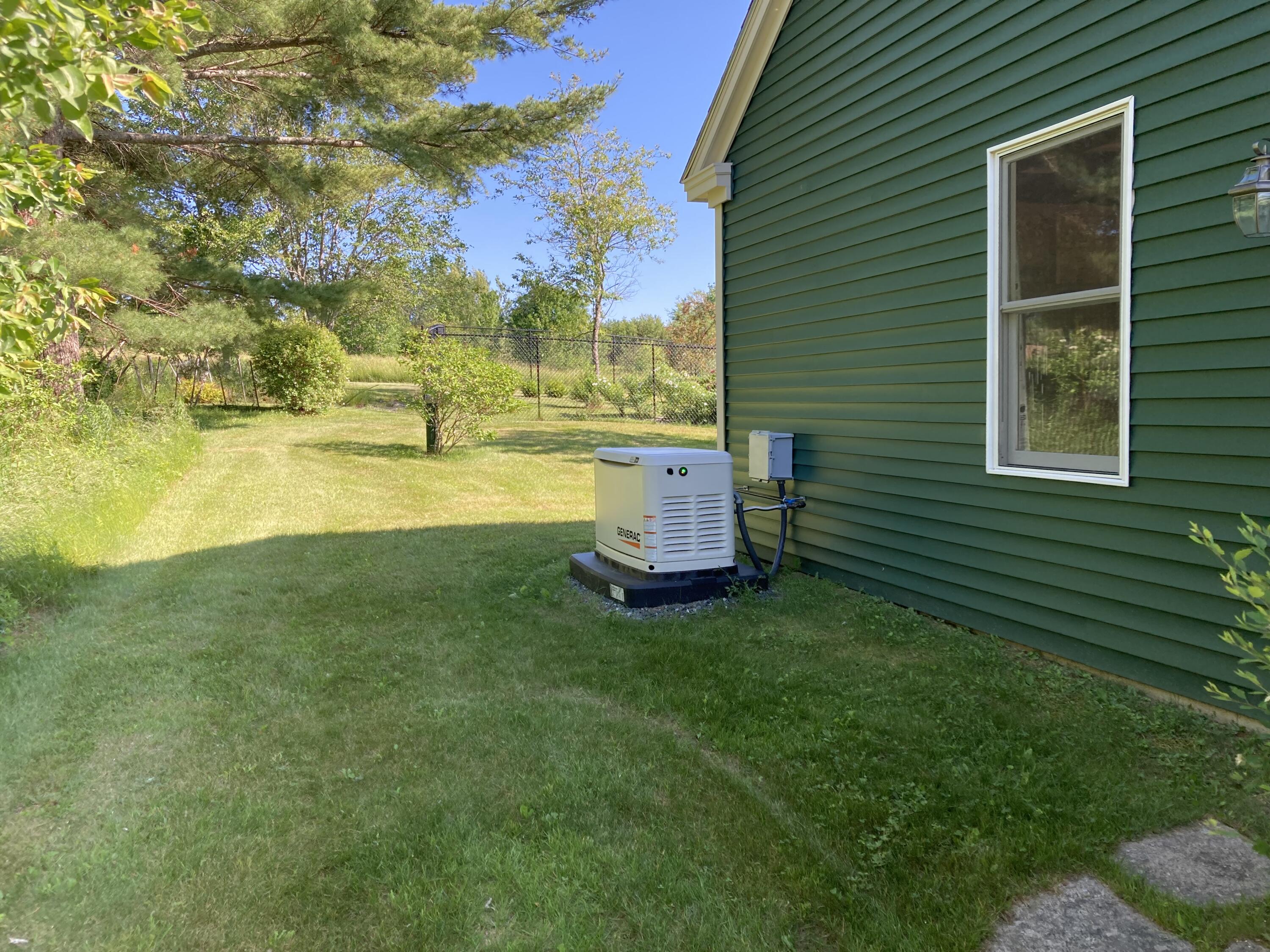 32 Boulder Cv Way Lamoine, ME 04605 - Photo 28 of 37 Full-house generator in side yard.