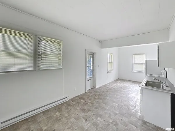 a kitchen with refrigerator and white stove