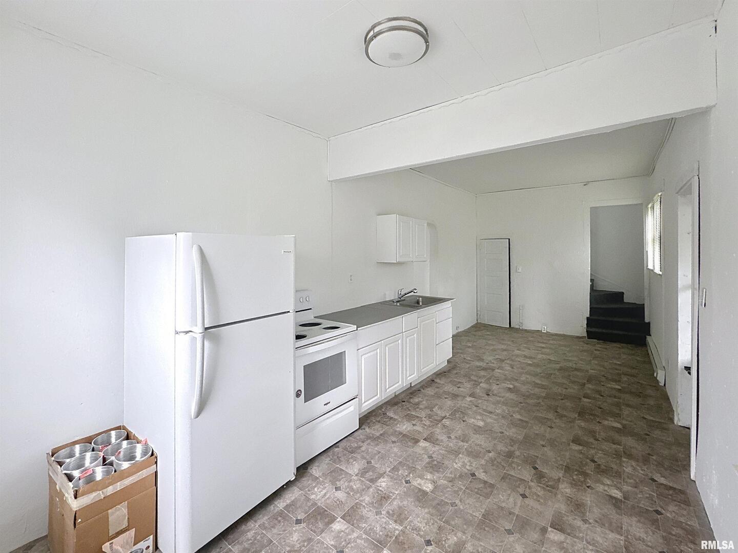 204 Main Avenue Matherville, IL 61263 - Photo 12 of 27 a kitchen with refrigerator and white stove
