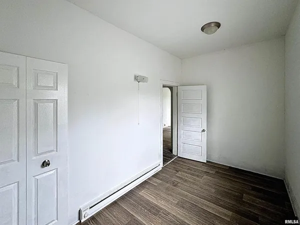 an empty room with windows and entrance