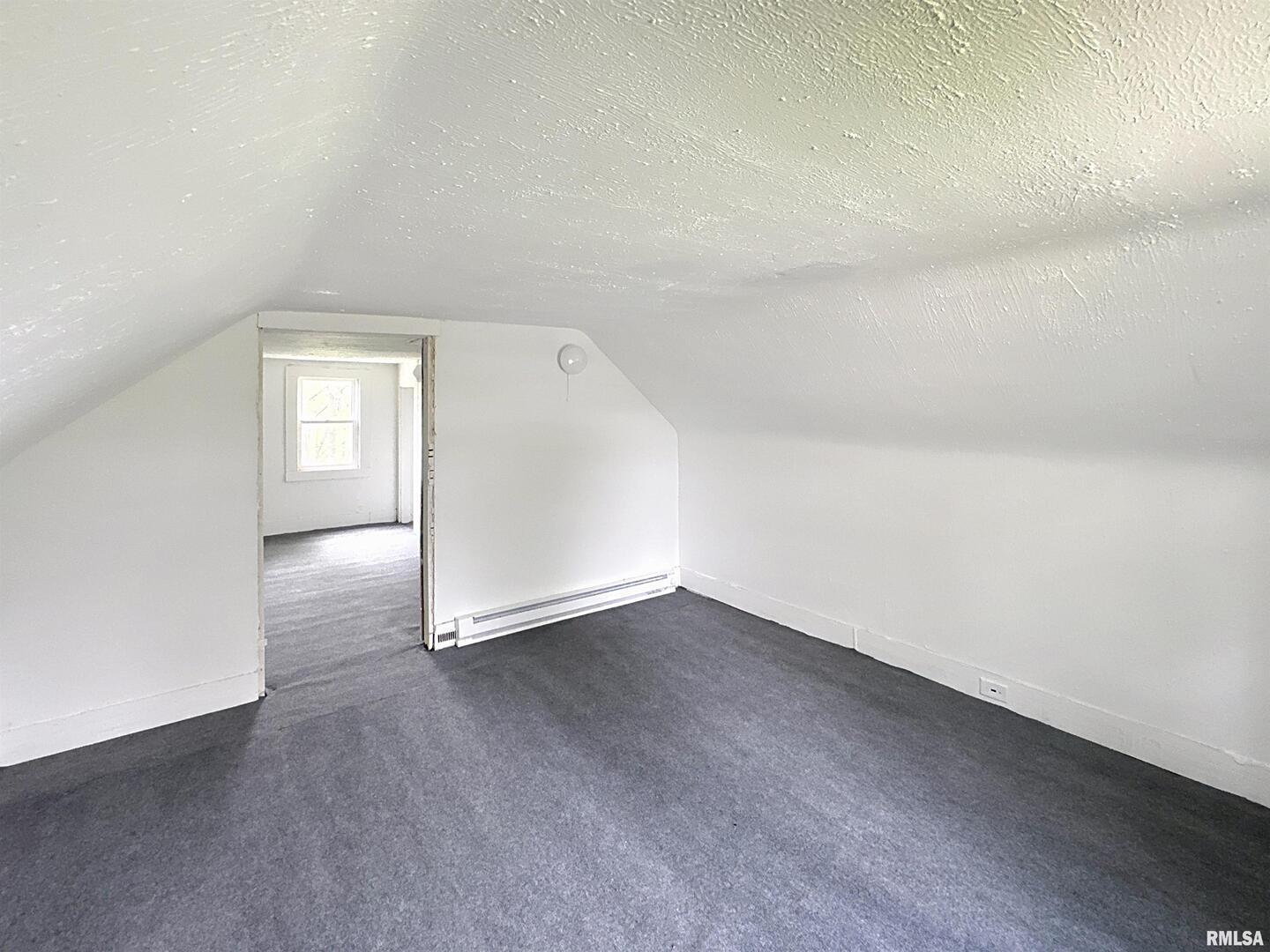 204 Main Avenue Matherville, IL 61263 - Photo 20 of 27 an empty room with wooden floor and windows