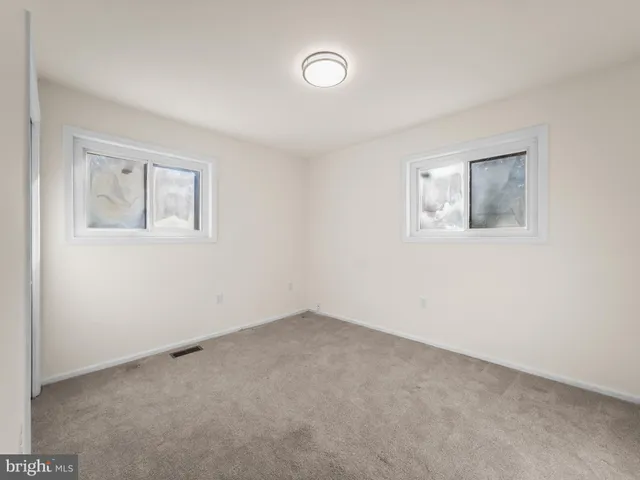 an empty room with windows and entrance