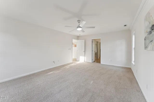 wooden floor fireplace and windows in an empty room