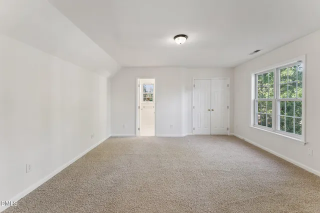 a view of a room with windows and ceiling fan