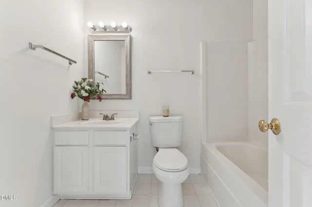 a bathroom with a sink a toilet and a window