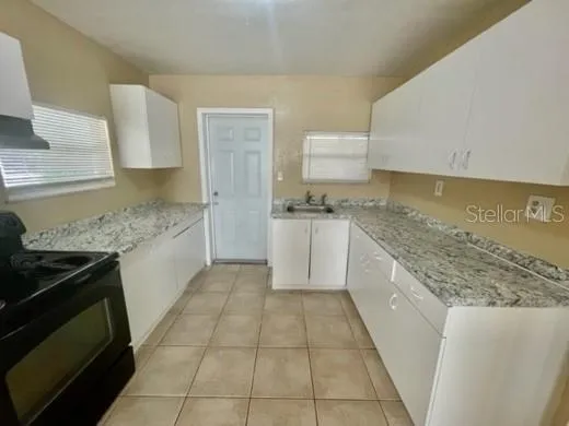 a kitchen with a cabinets and a stove top oven