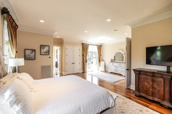 a large bathroom with a granite countertop tub a double vanity sink and a large mirror