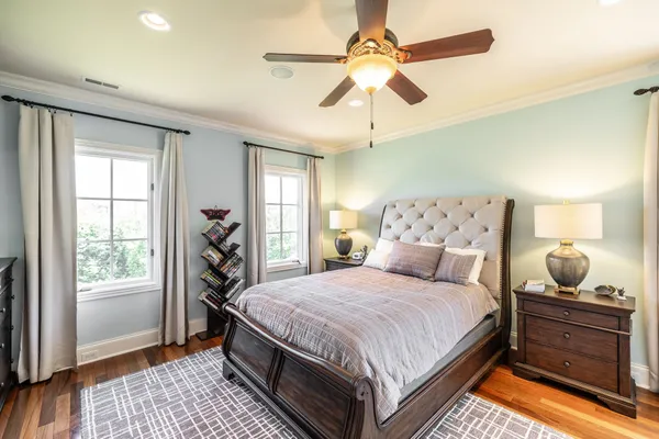 a bedroom with a bed and wooden floor