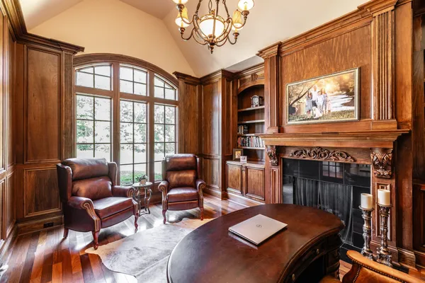 a living room with furniture a fireplace and a chandelier