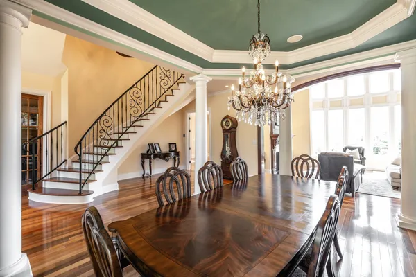 a view of a dining room with furniture a chandelier and wooden floor