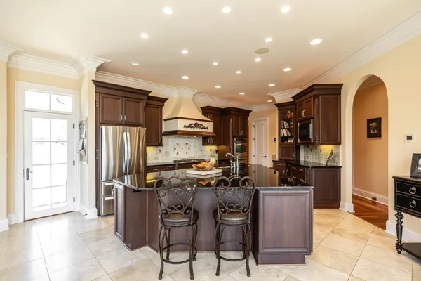 a kitchen with stainless steel appliances granite countertop a stove and a sink