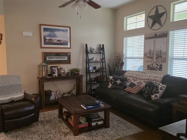 a living room with furniture and a large window