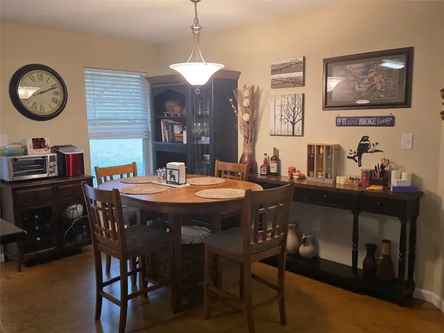 a dining room with a wooden table and chairs