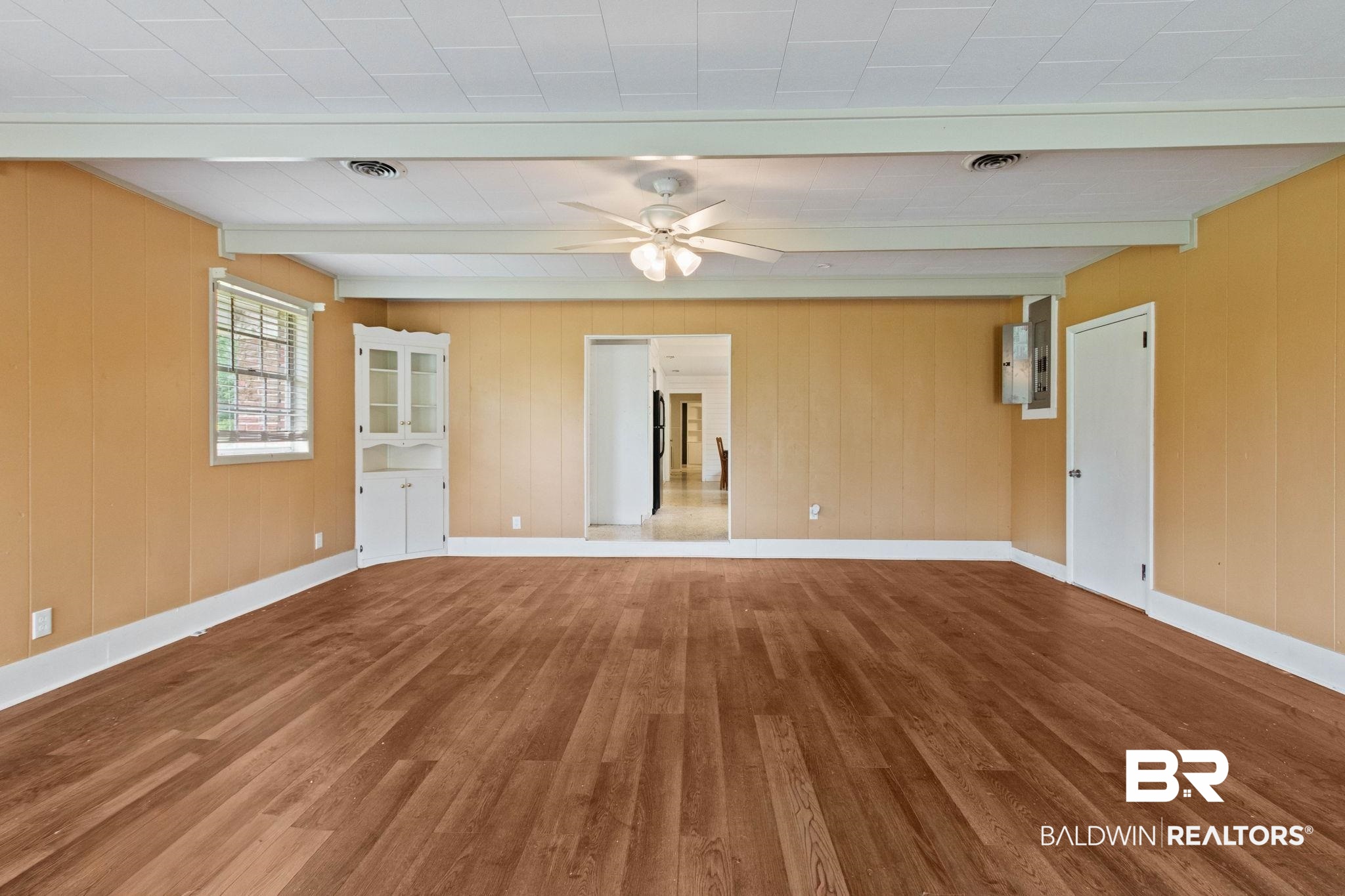 384 Old Bratt Road Atmore, AL 36502 - Photo 9 of 64 Expansive room featuring wood-finish flooring, a ceiling fan, and painted walls