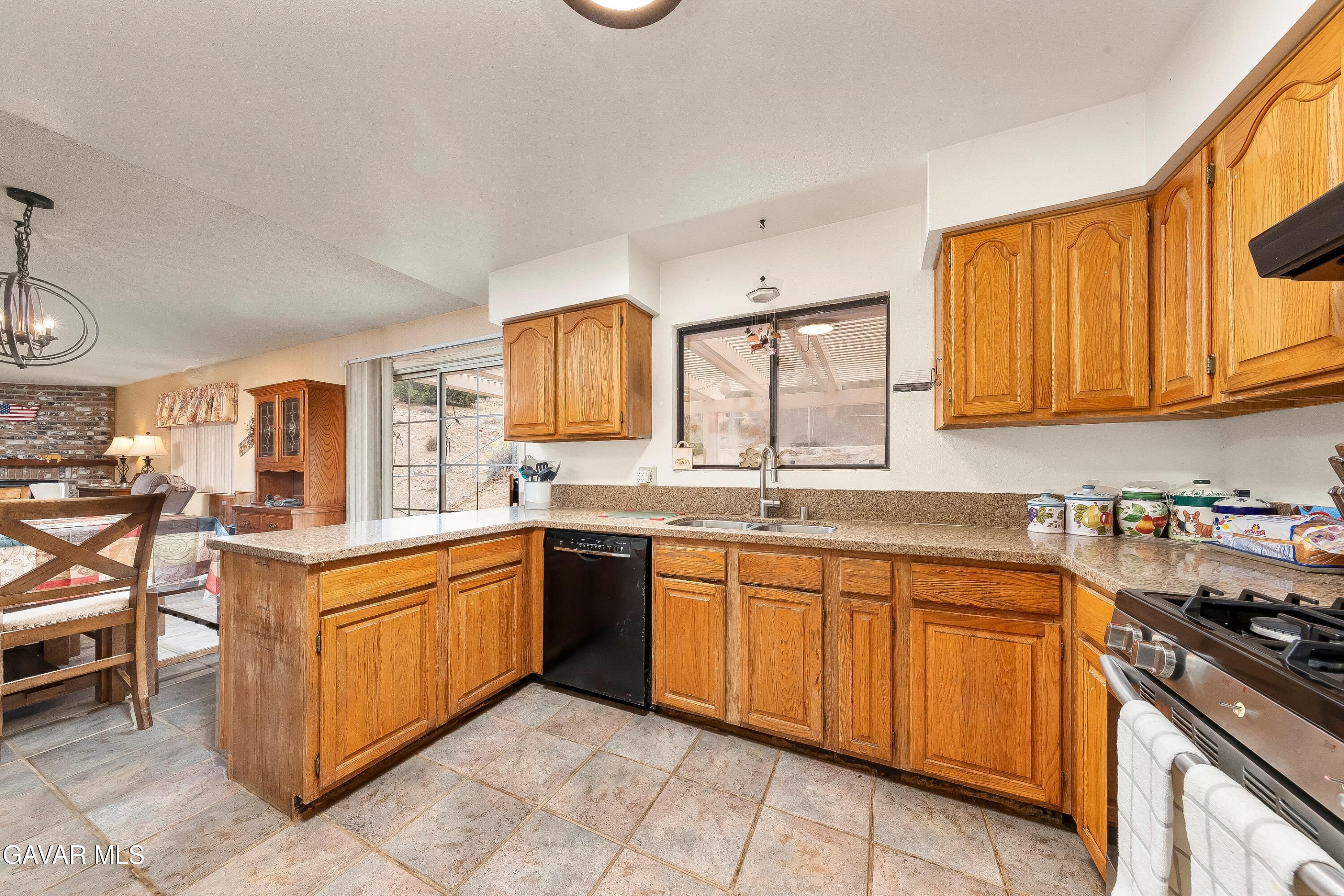 31741 Lake Meadow Road Acton, CA 93510 - Photo 15 of 59 a kitchen with stainless steel appliances granite countertop a sink and cabinets