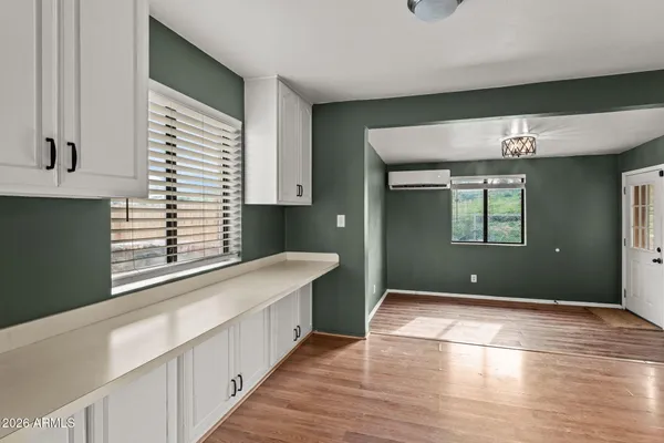 a view of a kitchen cabinets and a wooden floor