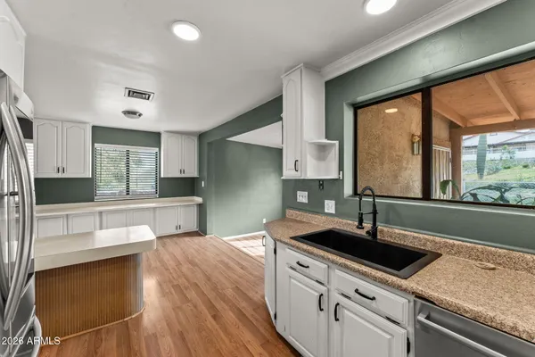 a kitchen with a refrigerator sink and stove