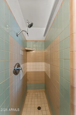 a bathroom with a tub sink and mirror