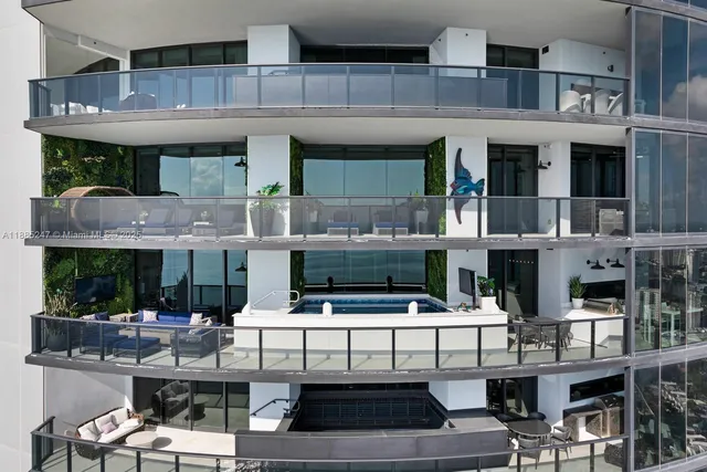 a kitchen with white cabinets and chairs