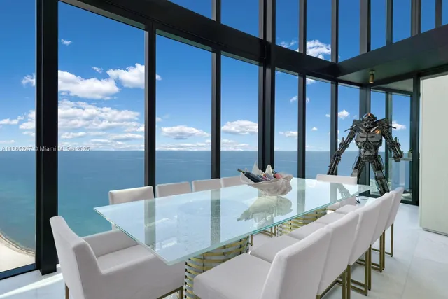 a view of an entryway with a table and chairs