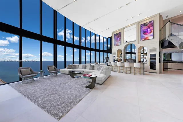 a large bedroom with a large window and a flat screen tv