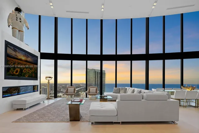 a living room with furniture large window and a flat screen tv