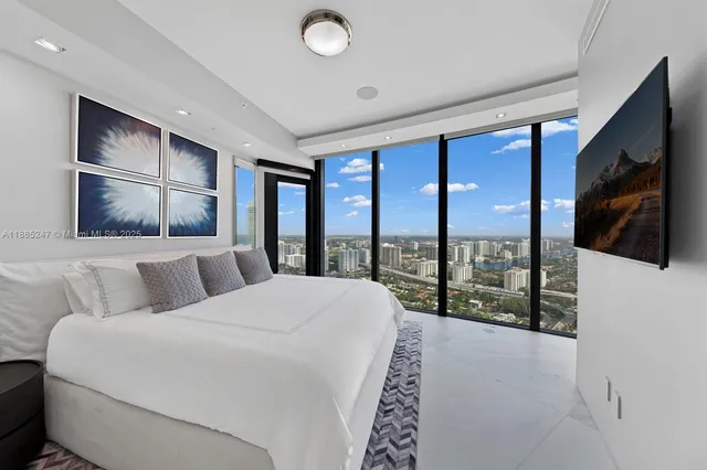 a spacious bedroom with a bed and a painting on the wall