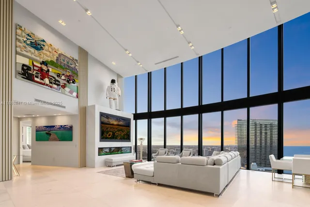 a living room with furniture tv and a large window