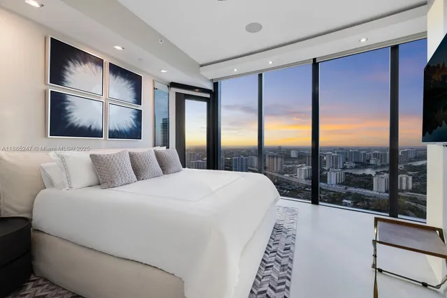 a bedroom with a bed and a flat screen tv