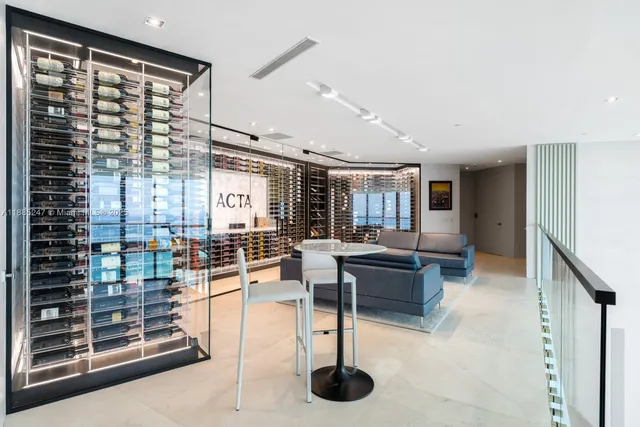 a spacious bedroom with a large bed and a chandelier