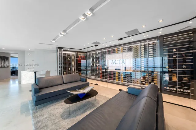 a bedroom with a large bed and a large window with balcony view