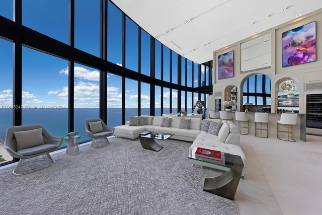 a living room with furniture and large window